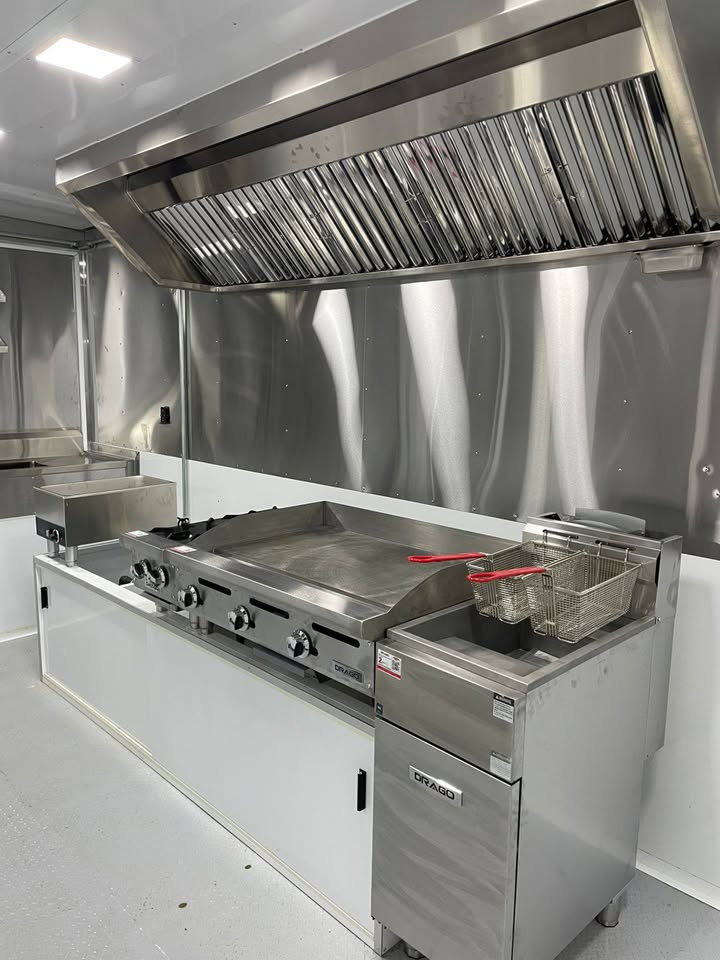 Close-up of flat-top griddle and fryer under hood