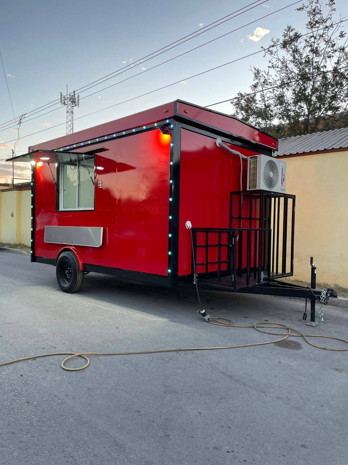 Red food trailer with porch and AC